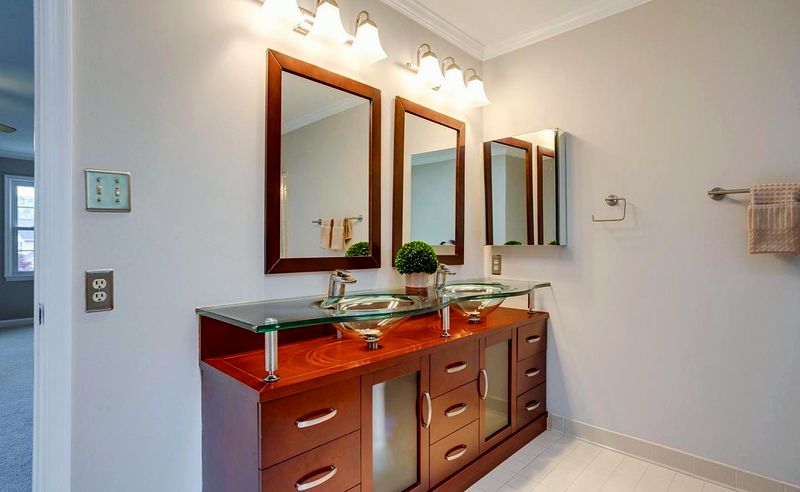 A bathroom with a double vanity and wide mirrors