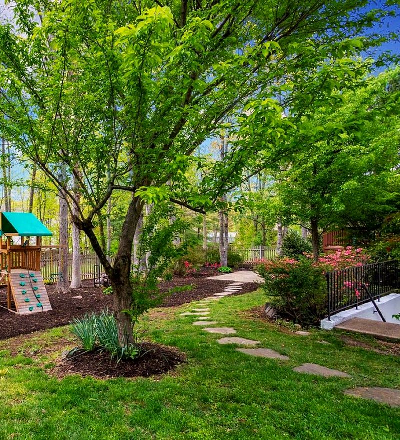 A stepping-stone path running through the planted garden border